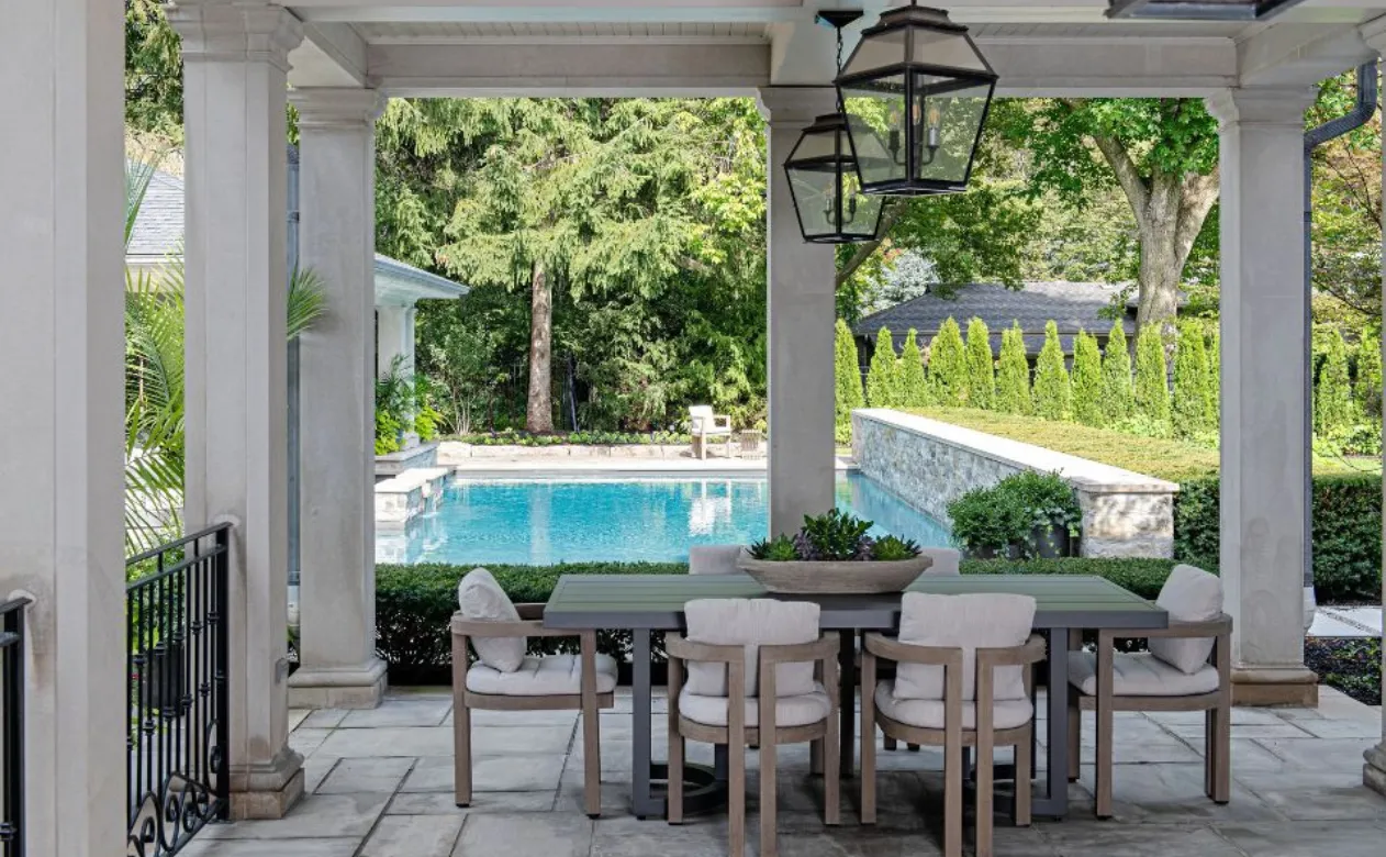 stone floor patio outside living space with outdoor furniture, lighting, and pool